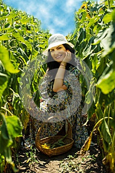 Beautiful smiling woman in sunflowers field