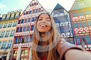Beautiful smiling woman take self portrait in Romerberg square in Frankfurt, Germany