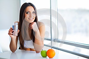 Beautiful Smiling Woman Taking Vitamin Pill. Dietary Supplement