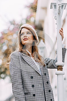 A beautiful smiling woman walking along a crowded city street. Street portraits in Istanbul.