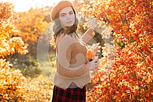 Beautiful smiling woman walking outdoors in autumn. Beauty Romantic Girl Outdoors enjoying nature. Portrait of romantic