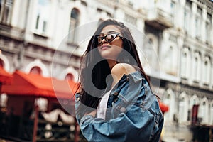 Beautiful smiling woman wearing denim jacket, trendy outfit, spring summer fashion trend, black sunglasses, street fashion,