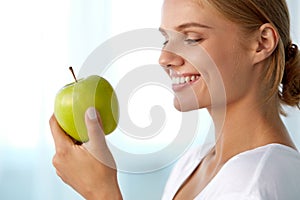 Beautiful Smiling Woman With White Teeth Eating Green Apple