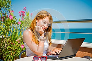 Beautiful smiling woman working on laptop.