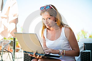 Beautiful smiling woman working on laptop.