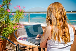 Beautiful smiling woman working on laptop.