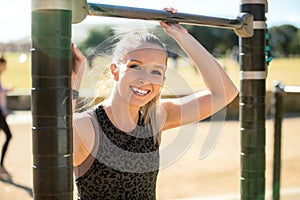 Beautiful smiling young blonde caucasian woman lifestyle headshot portrait during fitness routine at outdoor