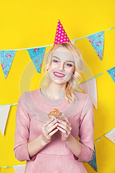 Beautiful smiling young blonde woman with a cake. Celebration and party.