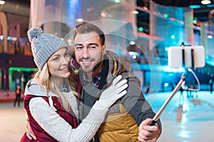 beautiful smiling young couple taking selfie with smartphone