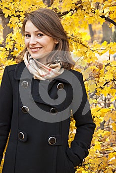 Beautiful smiling young girl in an autumn park