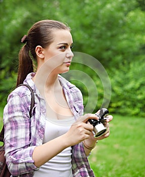 Beautiful smiling young girl with camera