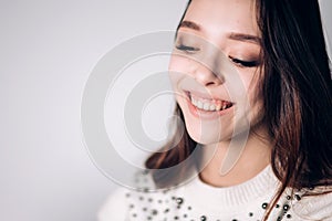 Beautiful smiling young woman closeup. Happy girl laughing on white background. Positive emotion.