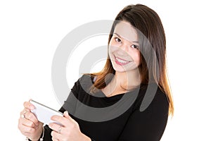 Beautiful smiling young woman holding a smartphone while text messaging texting isolated on white background