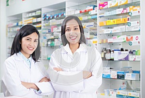 Beautiful smiling young woman pharmacist doing his work in pharmacy