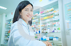 Beautiful smiling young woman pharmacist doing his work in pharmacy