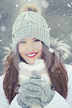 Beautiful smiling young woman in warm clothing. The concept of p