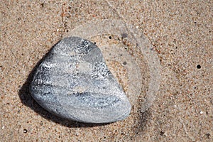 Beautiful smooth sea stones in the sands of the beach.