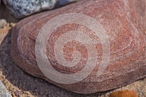 Beautiful smooth sea stones in the sands of the beach.