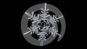 Beautiful Snowflake Close-up Seamless Rotation Isolated on Black Background with Alpha Mask. Looped 3d Animation of