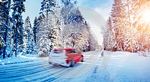 Beautiful snowy country road in winter with cars on it.