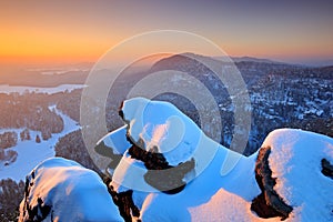 Beautiful snowy evening in the rocks. Before Sunrise in a beautiful mountain landscape of Czech-Saxony Switzerland. Winter in the