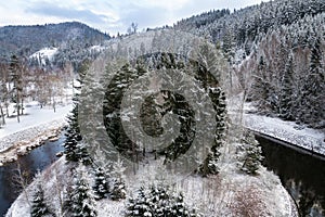 Beautiful snowy winter forest landscape, Tepla River under Brezova dam