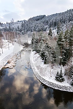 Beautiful snowy winter forest landscape, Tepla River under Brezova dam