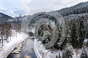 Beautiful snowy winter forest landscape, Tepla River under Brezova dam