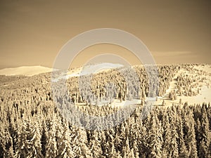 Beautiful snowy winter landscape in a mountain ski resort, retro sepia style