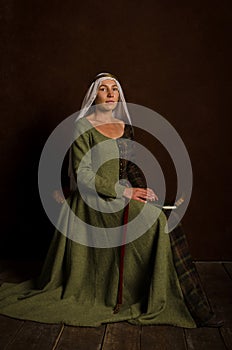 Beautiful sophisticated girl actress in a medieval costume of the 14th century central Europe. Hobby - reconstruction of
