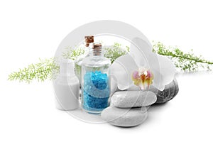 Beautiful spa composition with bottle of sea salt and stones on white background