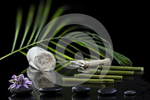 Beautiful spa composition with passiflora, bamboo and stones on black background