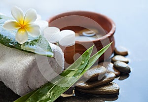 Beautiful spa composition with small bottles, flowers, stones