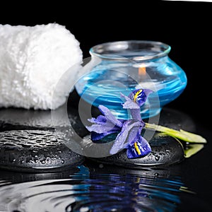 Beautiful spa concept of iris flower, blue candle, white towel a