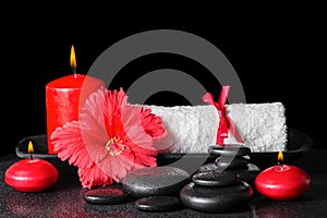 Beautiful spa concept of red hibiscus flower with dew, candles a