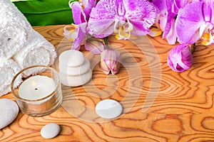 Beautiful spa setting with blooming lilac orchid, white stones,