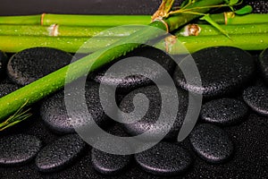 Beautiful spa setting of zen basalt stones and natural bamboo st