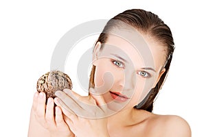 Beautiful spa woman holding Rose of Jericho