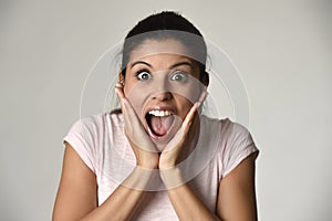 Beautiful Spanish surprised woman amazed in shock and surprise happy and excited