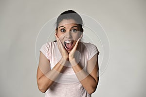 Beautiful Spanish surprised woman amazed in shock and surprise happy and excited