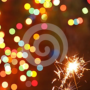 Beautiful sparklers on the background of a garland. beautiful holiday card for the New Year