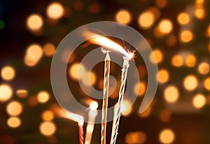 Beautiful sparkles from sparklers on the background of New Year\'s bokeh