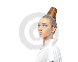 Beautiful spectacular blonde lady with an unusual high hairdo with big blue eyes on a white background
