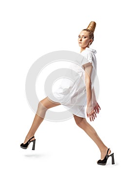 Beautiful spectacular blonde lady with an unusual high hairdo on a white background