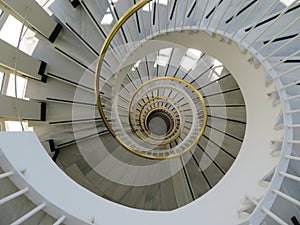 Beautiful spiral staircase with golden handrails design circular shapes photo