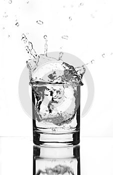 A beautiful splash of ice in a glass of water
