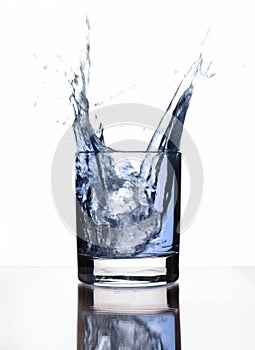 A beautiful splash of ice in a glass of water