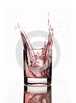 A beautiful splash of pink water in a glass