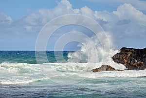 Beautiful splashes of waves hitting the stony shore