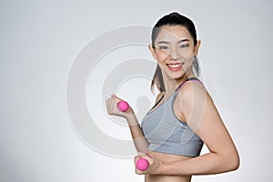 Beautiful sport slender woman with pink dumbbell